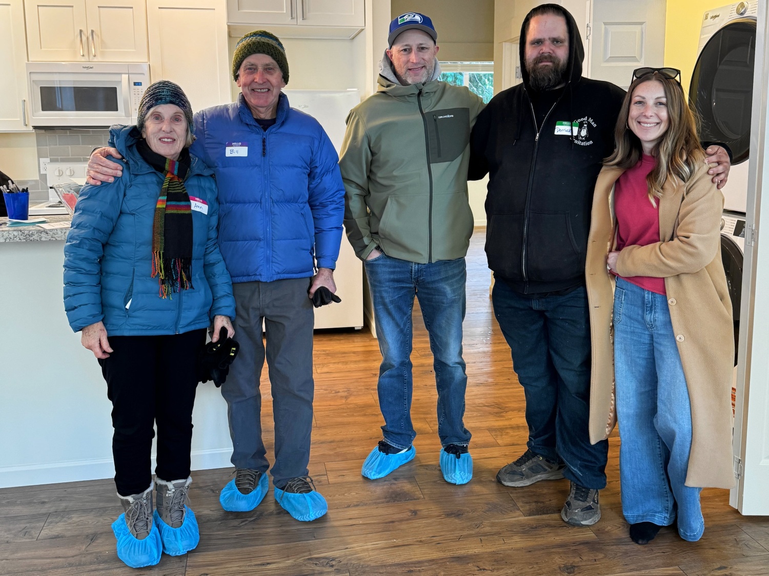 Bill and Ann Testerman, left, with Derrick and his family in Derek's new home